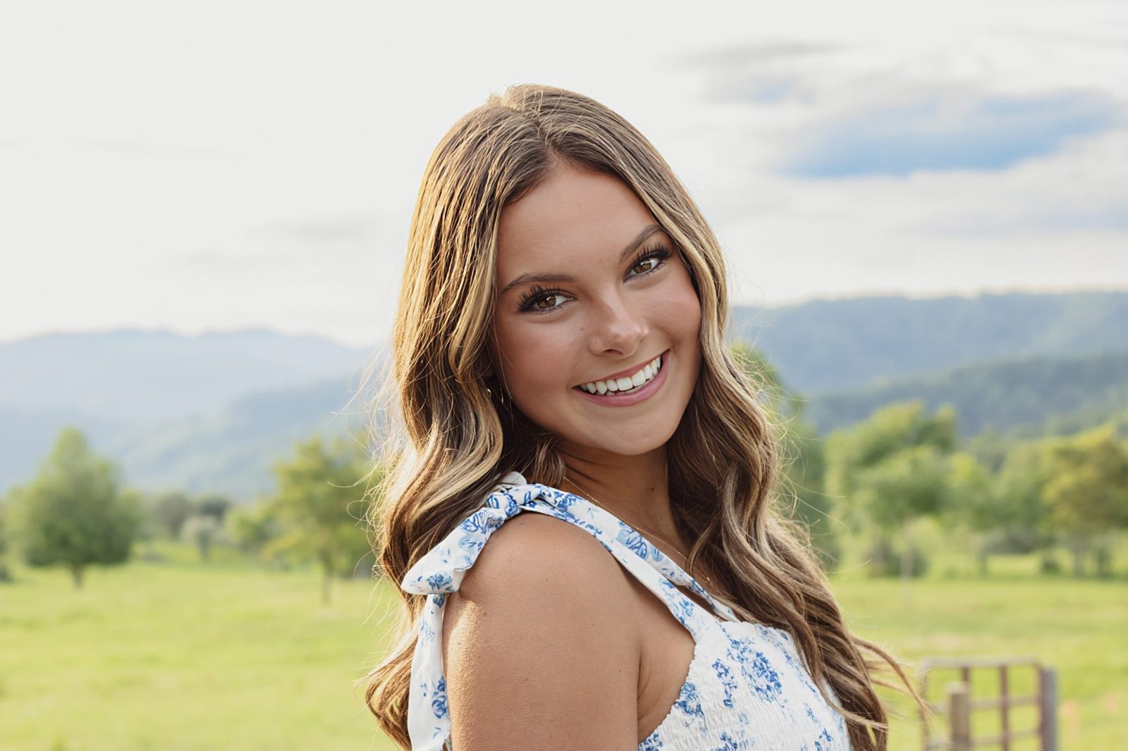Smiling senior with mountains behind her