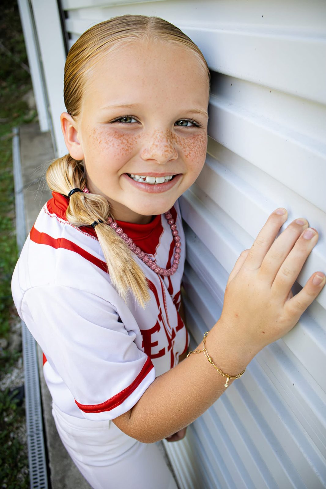 Young softball player in her Belfry uniform